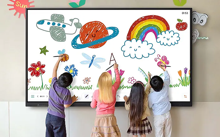 Four kids drawing on a large interactive screen filled with colorful doodles like a rainbow, sun, plane, and flowers.