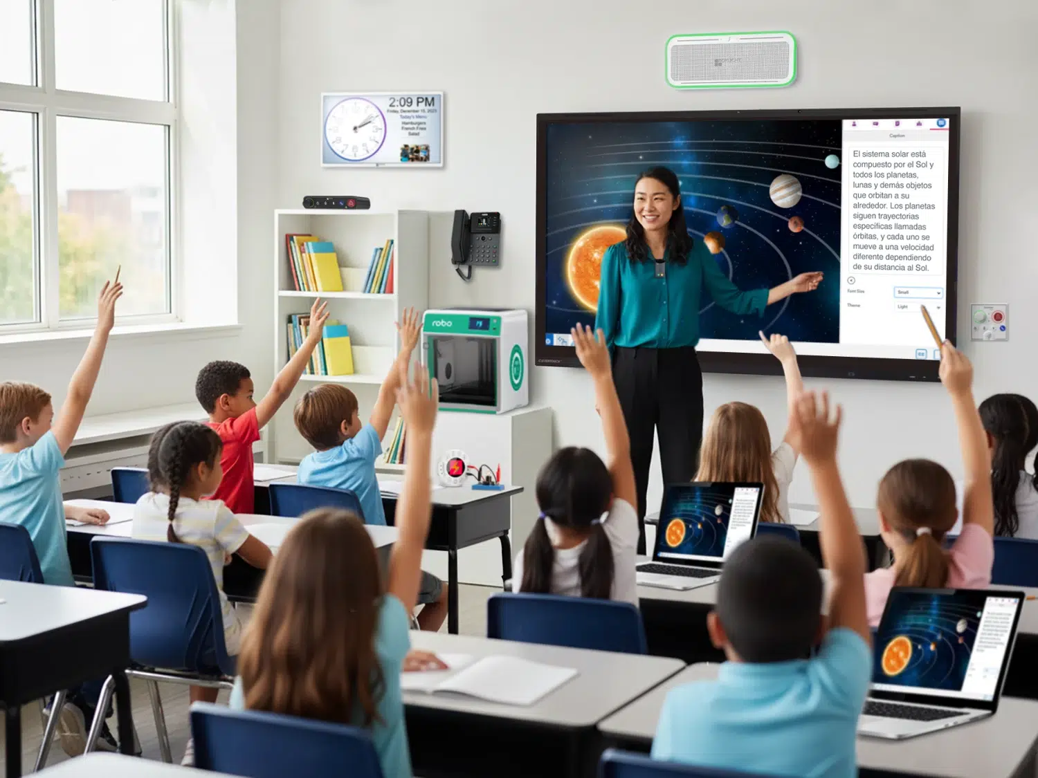 Teacher leads a space science lesson at a large interactive screen while students raise hands in a bright classroom.