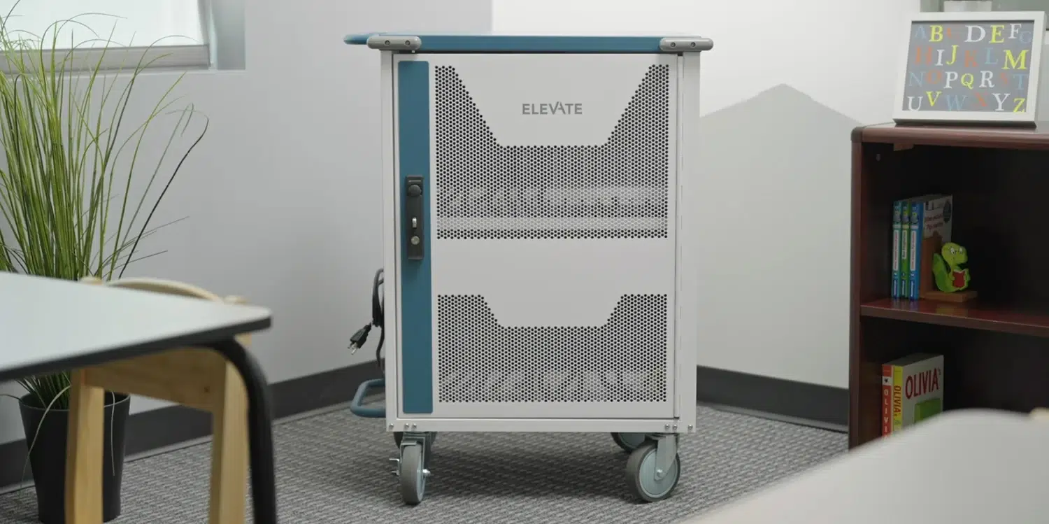 Mobile equipment cart with perforated panels and the word 'ELEVATE' on the front, in a classroom setting near a bookshelf and plants.