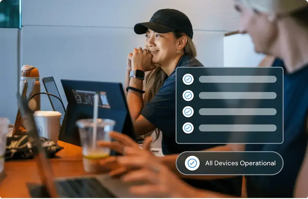 Woman wearing a cap at a workspace, with a dashboard overlay showing all devices operational.